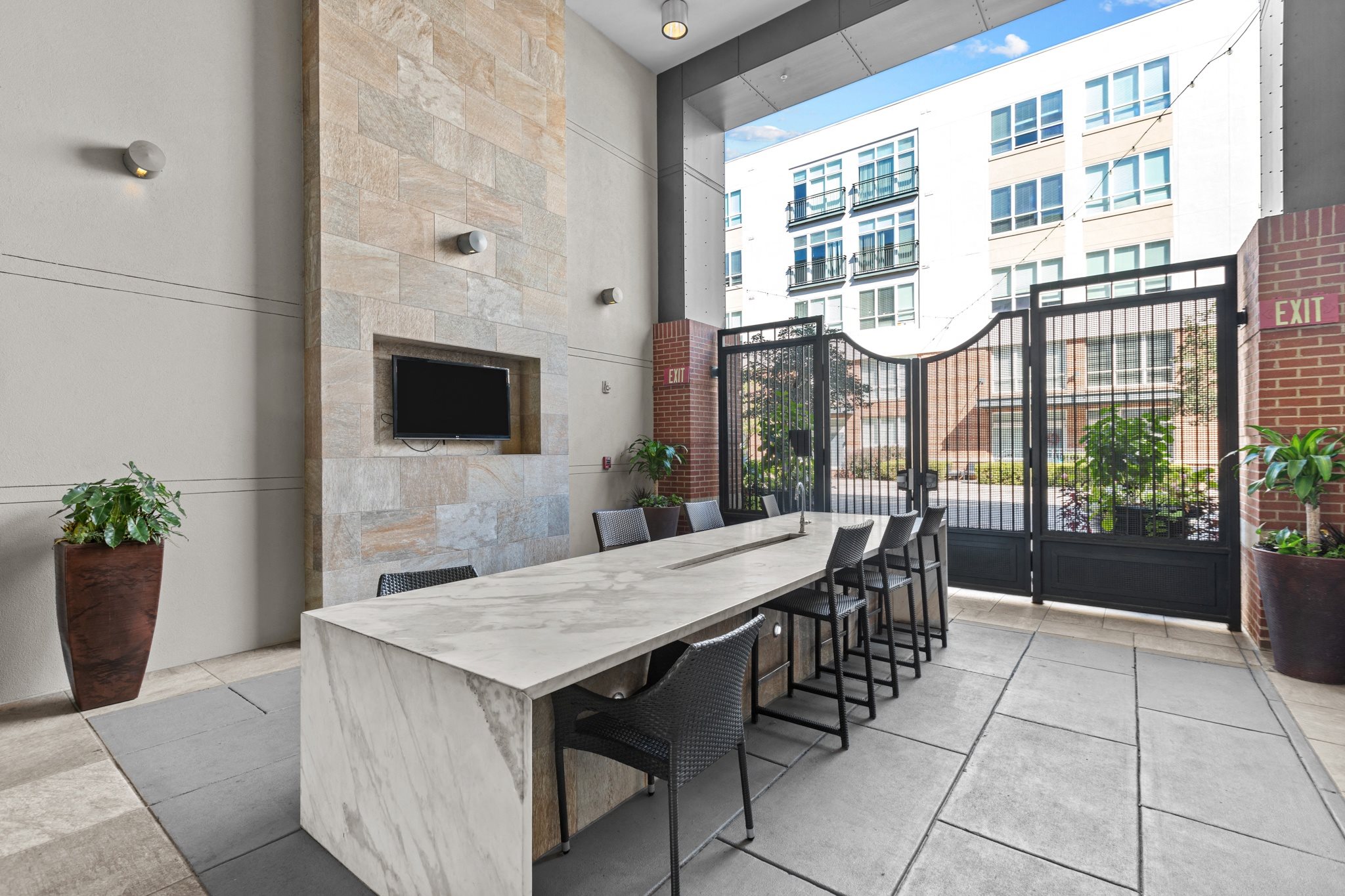 a long table with chairs in a room with a fireplace and a window